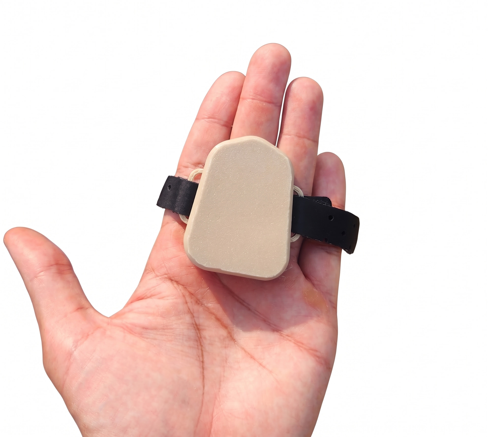 HydroBear wearable held in an open hand